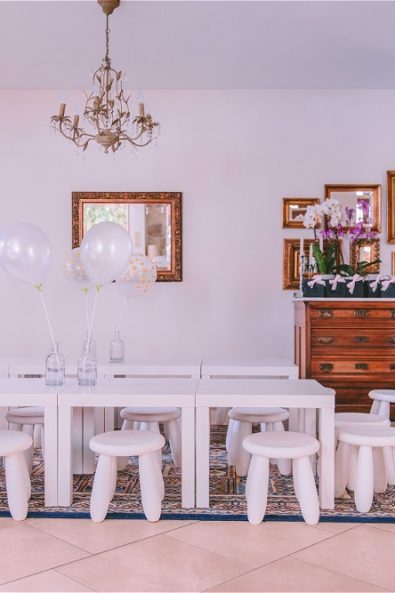 Interior Minnie Mouse Party decorations with white stools and baloons
