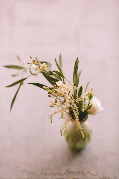 Wedding flower arrangement with little pale pink flowers and white roses.
