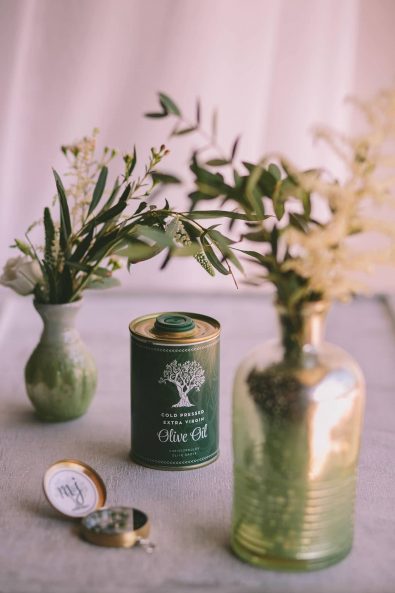 Olive oil wedding favors and vases with olive branches for a destination wedding in kalamata.