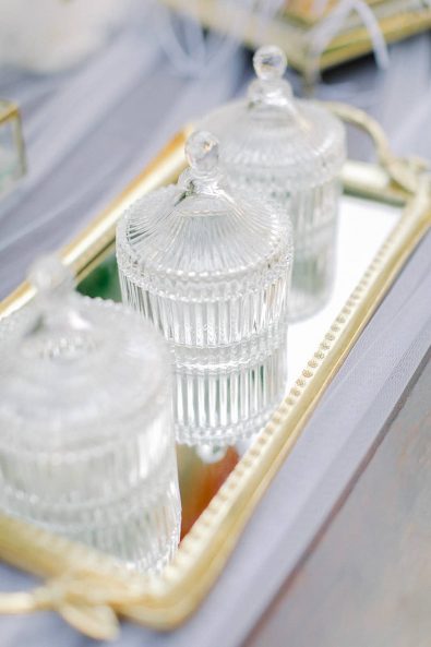 Crystal candy boxes on a gold tray.