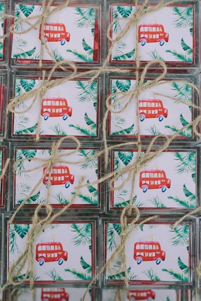 Christening baby baptism favor boxes for a boy with a red bus and a string tie.
