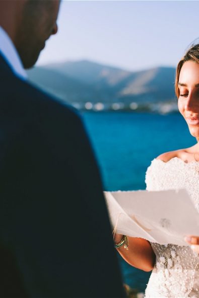 bride looking at vows in elopement in Paros