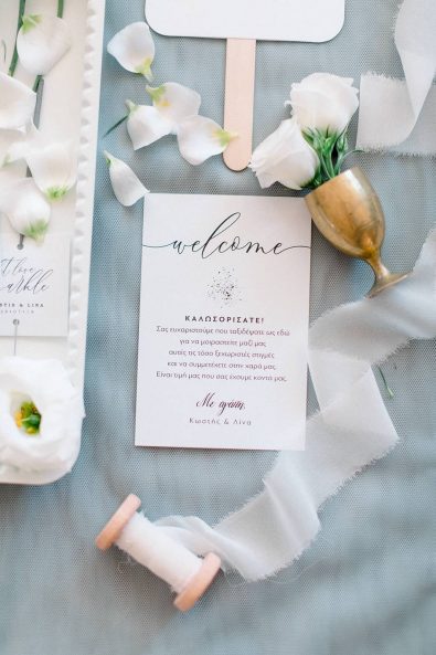 Welcome wedding card and stationery in cream and gold details.