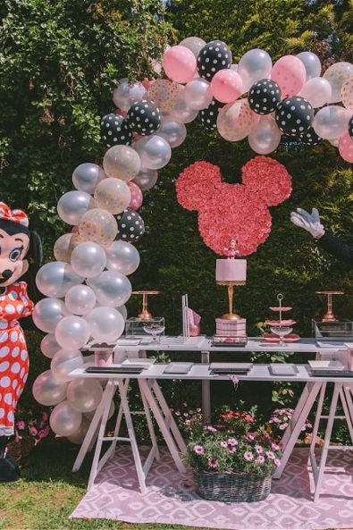 Minnie and Mickie Mouse posing in front of candy bar