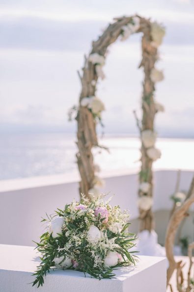 Wedding decoration flower arrangement with eucalyptus, summer flowers, peonies and roses for the wedding reception of a destination wedding in kalamata.
