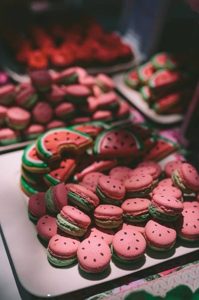 Watermelon inspired green and red macarons and watermelon slice sugar cookies for a baptism ceremony.