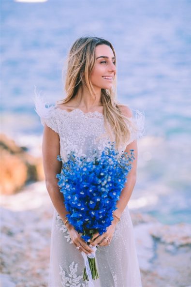 Bride holding flowers looking to her left