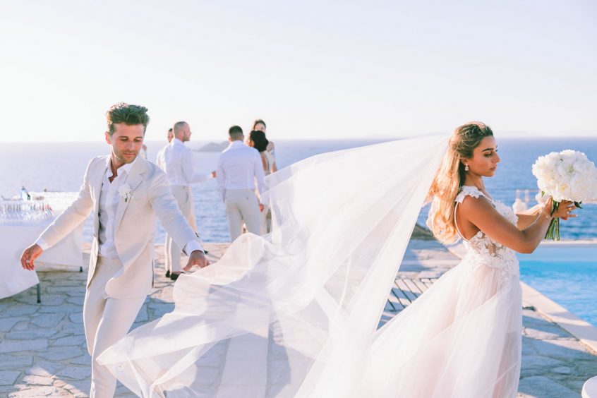 Groom and bride in white wedding veil