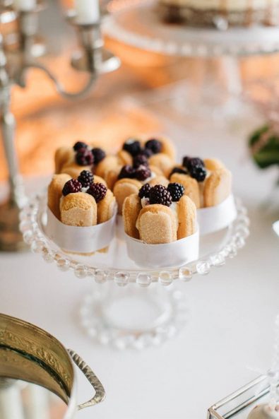 Mini charlottes french dessert with blueberries and pale grey satin ribbon.