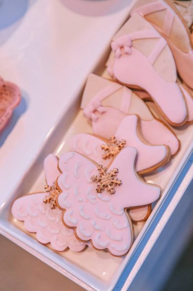 Ballet dress and ballet slippers pointe shoes biscuits with light pink sugar paste and rose gold snowflake decoration.