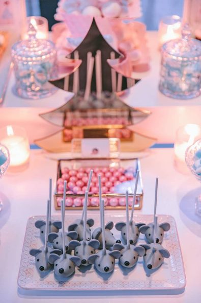 Grey mouse shaped cake pops on a pink and white serving tray for a Nutcracker ballet theme christening event.