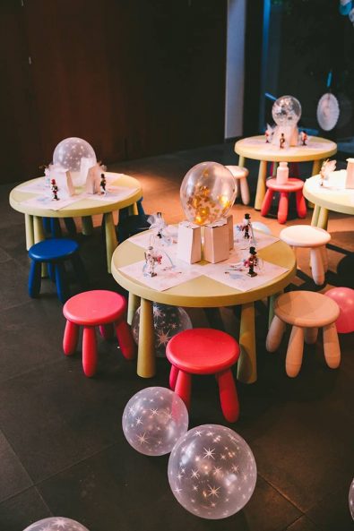 Children playroom party decoration with confetti and star balloons, nutcrackers and printed placemats.