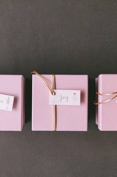 The three wishes of Christmas nutcracker inspired christening favors bombonieres in light pink boxes and gold string.