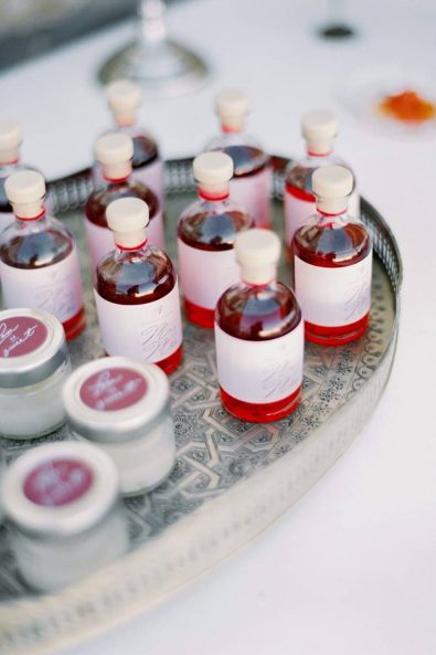 Custom made glass bottle pomegranate liqueur wedding favors.