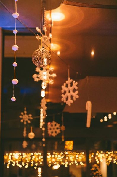 Christmas hanging decoration snowflakes, candy canes and bronze bauble.