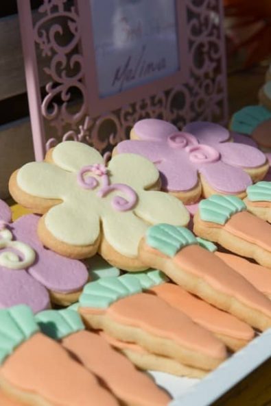 Butter biscuits with sugar paste shaped like flowers and carrots.
