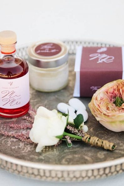 Wedding welcome gifts with traditional products, pomegranate liqueur and wedding favor in a white box.