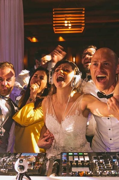 The bride, groom, Katerina Strimmenou wedding planner and couple's friends singing their hearts out and having fun at a destination wedding party in Kalamata, Greece.