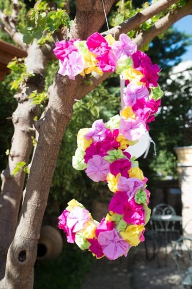 Number 3 Party sign with magenta, purple, yellow and green tissue paper flowers.