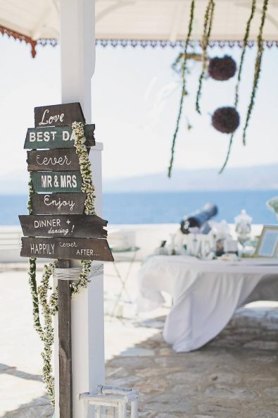 Wooden wedding decor party signs with white flower garlands.