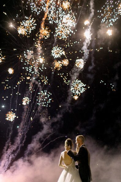 Fireworks in the night sky at wedding ceremony of couple