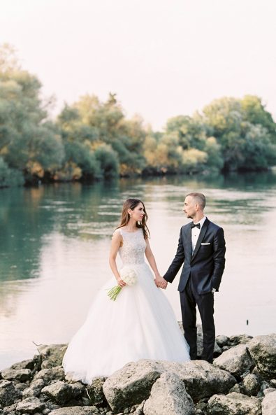 Couple holding hands at their lake wedding in messolonghi