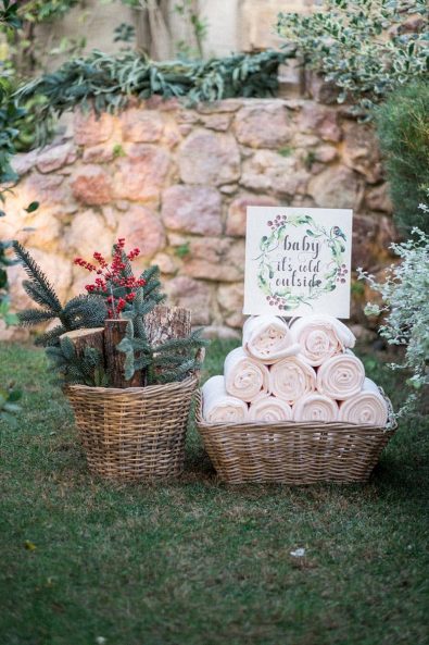 Blush colored warm fleece blankets for an outdoor festive ceremony and winter berries decoration.