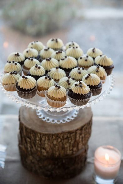 Chocolate and vanilla mini cupcakes for a birthday party with vanilla buttercream frosting and chocolate beads decoration.