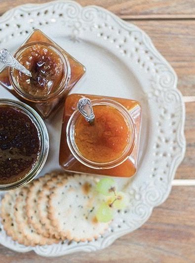 Party platter with marmalade jars and crackers.