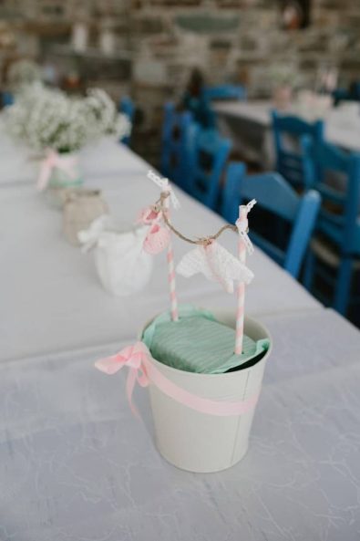 Baby laundry inspired centerpiece decoration for celebratory dinner, with crochet dresses hanging.
