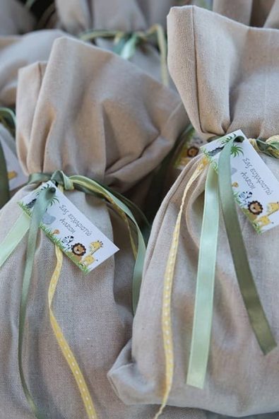 Custom made christening favors for baby boy with jungle animals and green ribbons for a boy baptism.