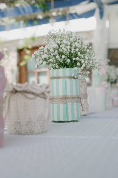 After baptism dinner custom made centerpieces with jars and white flowers.