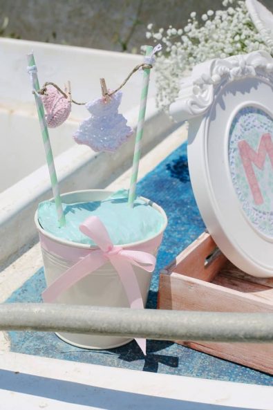 Christening ideas party decoration with hanging dress laundry from a string.