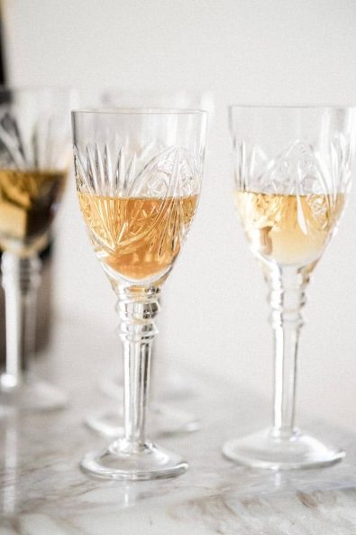 Vintage champagne in crystal glasses on a marble surface.