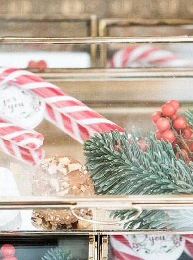Festive party favor with candy cane, Christmas treat and thank you note.