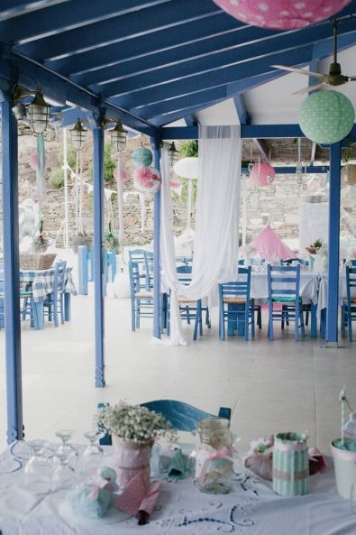 Picturesque Greek island summer restaurant decorated for a baby girl's christening event.