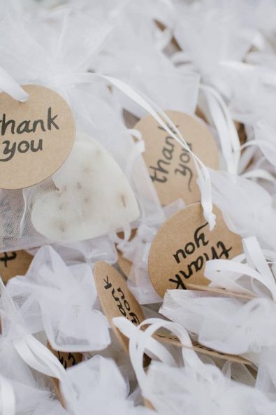 Thank you baptism favors with handmade lavender soap in white organza gift bags.