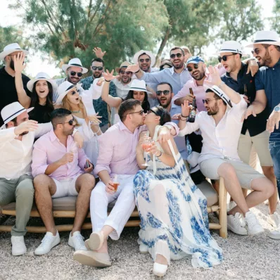 Couple is kissing next to their guests at their post wedding event in Island escape venue