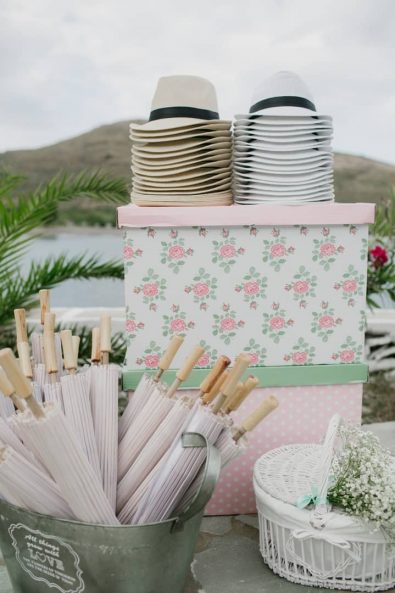 christening ideas - Paper sun umbrellas and beige and white straw hats for quests.