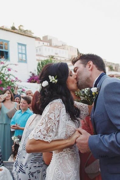 Bride and groom kissing in front of their friends and family.