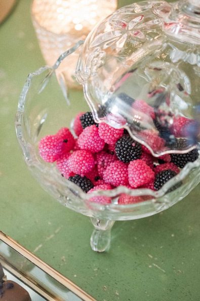 Crystal candy jar with blueberry and raspberry candy.