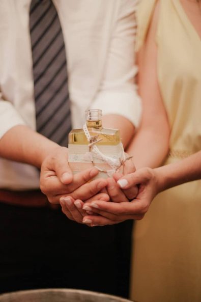 christening ideas - Godparents holding the oil bottle before an Orthodox Christening.