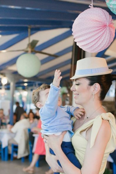 A mother with her baby boy dancing at a christening baptism party reception in Kythnos island Greece.