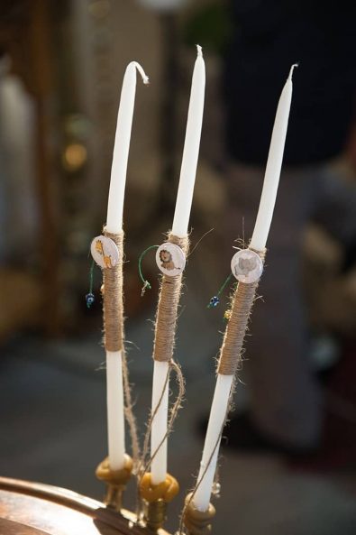 Baptistery candles decorated with burlap string and jungle animals for a boy baptism.