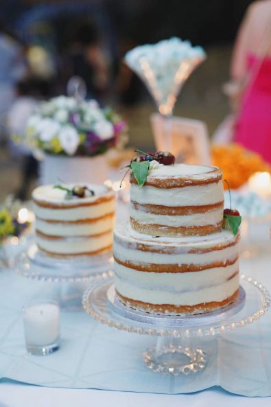 Minimal naked wedding cake with fruit.
