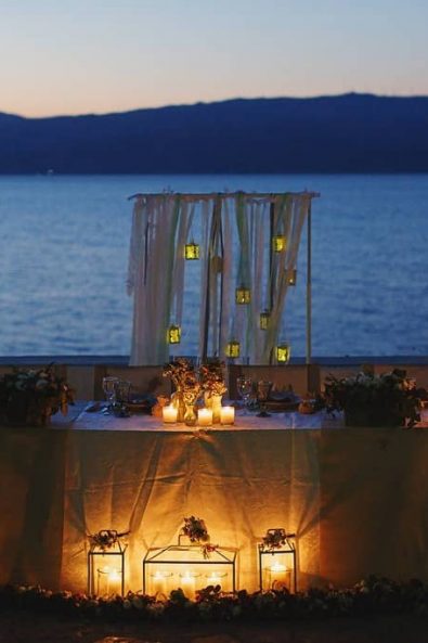 Beautiful scenery with a decorated table with candles for a destination wedding in Greece.