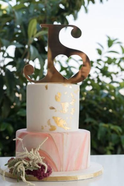 Peach and gold wedding cake with copper wedding topper for a Greek-Arabic wedding in Greece.