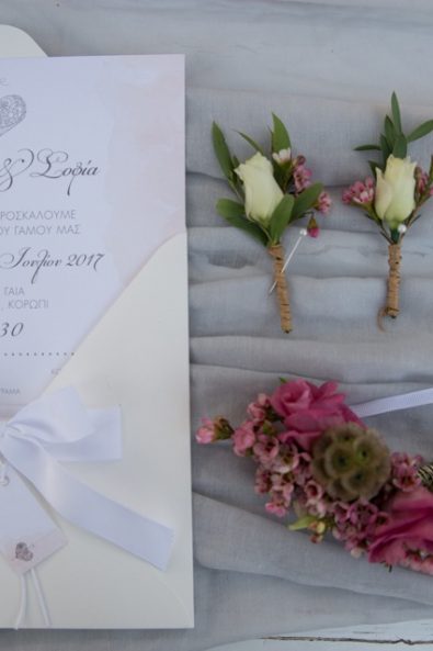 Romantic wedding invitation, fresh flower boutonniere, and pink roses and amaranthus bridal corsage.