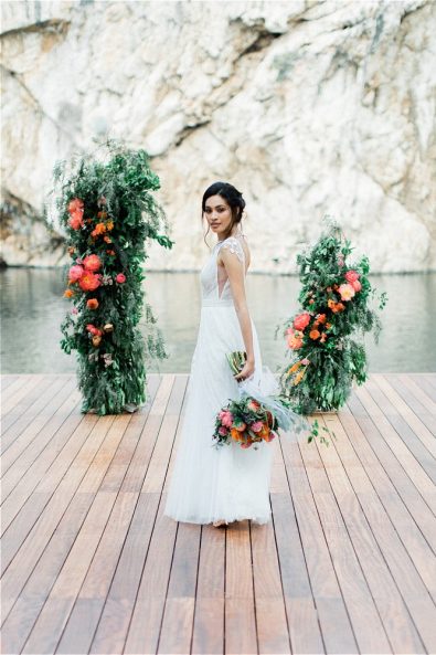 Bride on aisle holding wedding bouquet