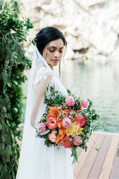Bride looking down at wedding bouquet